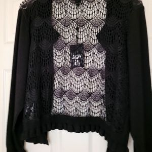 Black, long sleeve knit shrug, with lace back, and narrow ruffle detail